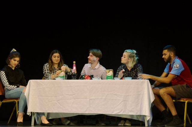 Friends talking round a dinner table