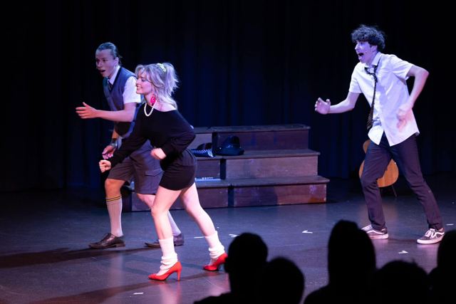 Performers running across the stage