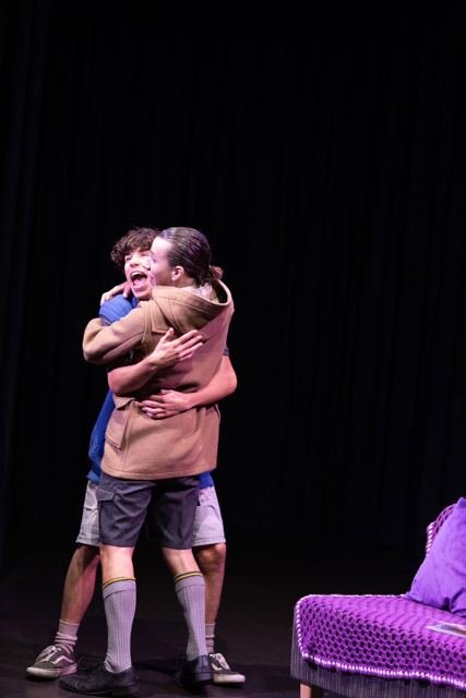 Two performers hugging tightly