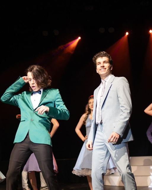 Two young men in jackets dancing